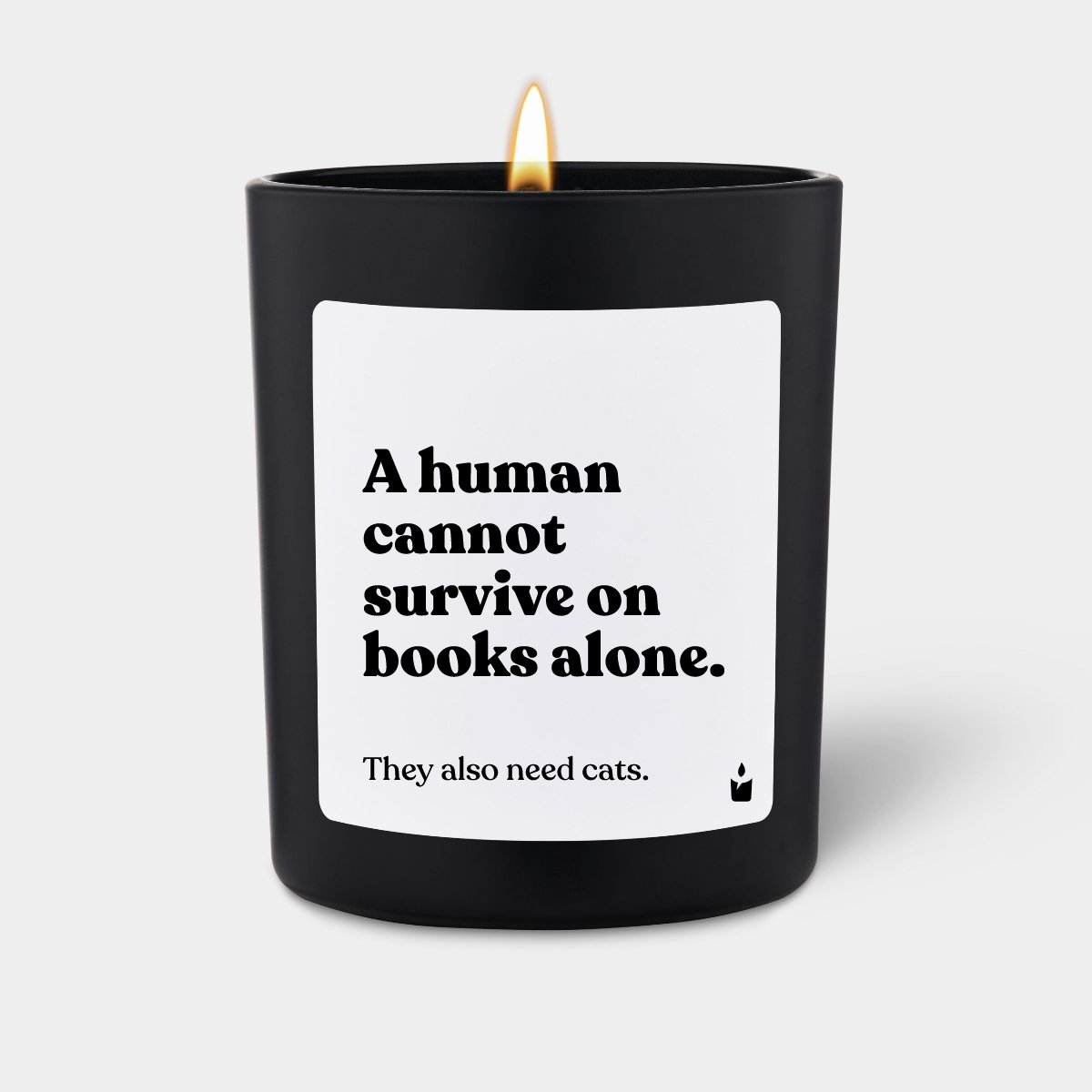 Duftkerze Schwarz Woody A human cannot survive on books alone. They also need cats.